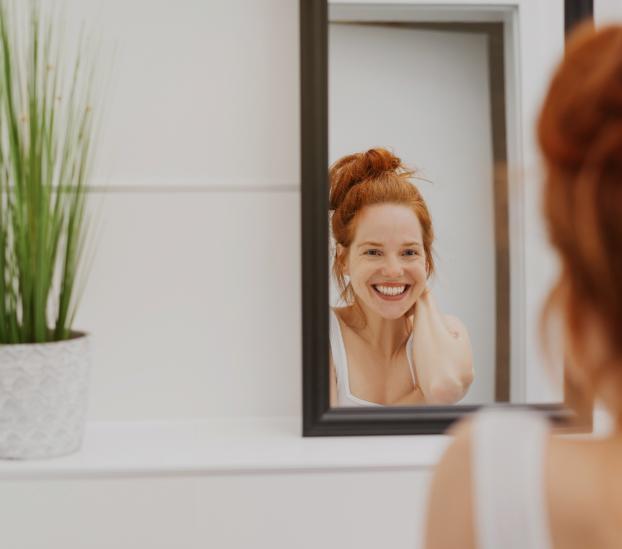 Picture of a lady smiling in mirror